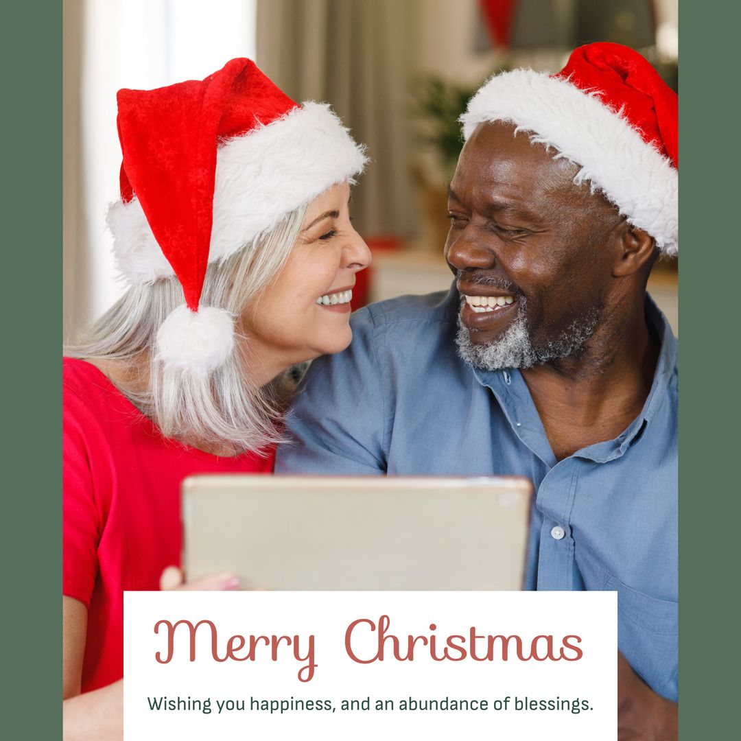 Joyful Older Couple in Festive Santa Hats Sharing Tablet