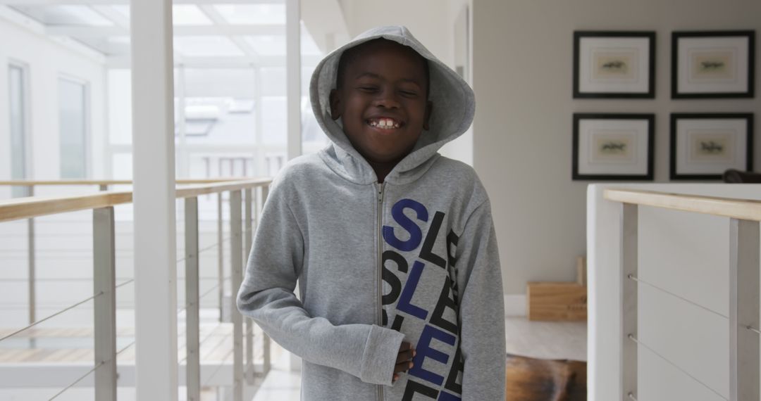 Portrait of happy african american boy wearing hoodie smiling at home - Free Images, Stock Photos and Pictures on Pikwizard.com