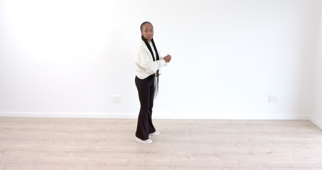 Woman Exercising in Minimalist Room Showing Fitness Routine