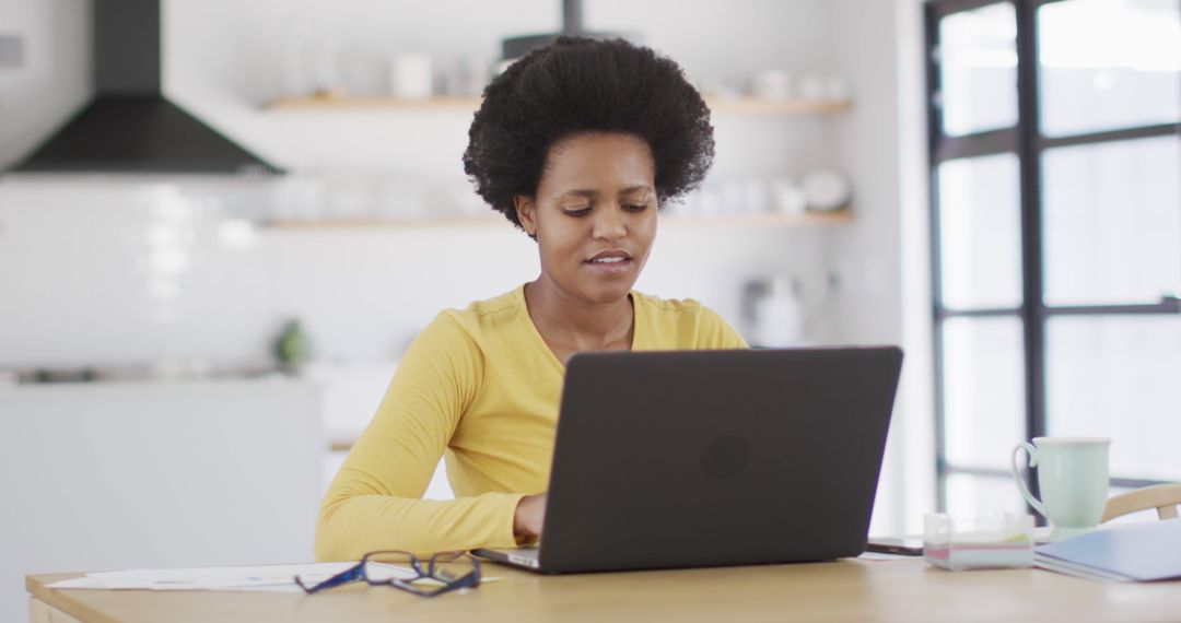 Young African American Woman Working Remotely on Laptop at Home - Free Images, Stock Photos and Pictures on Pikwizard.com