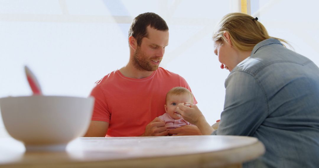 Parents Feeding Their Baby at Home - Free Images, Stock Photos and Pictures on Pikwizard.com