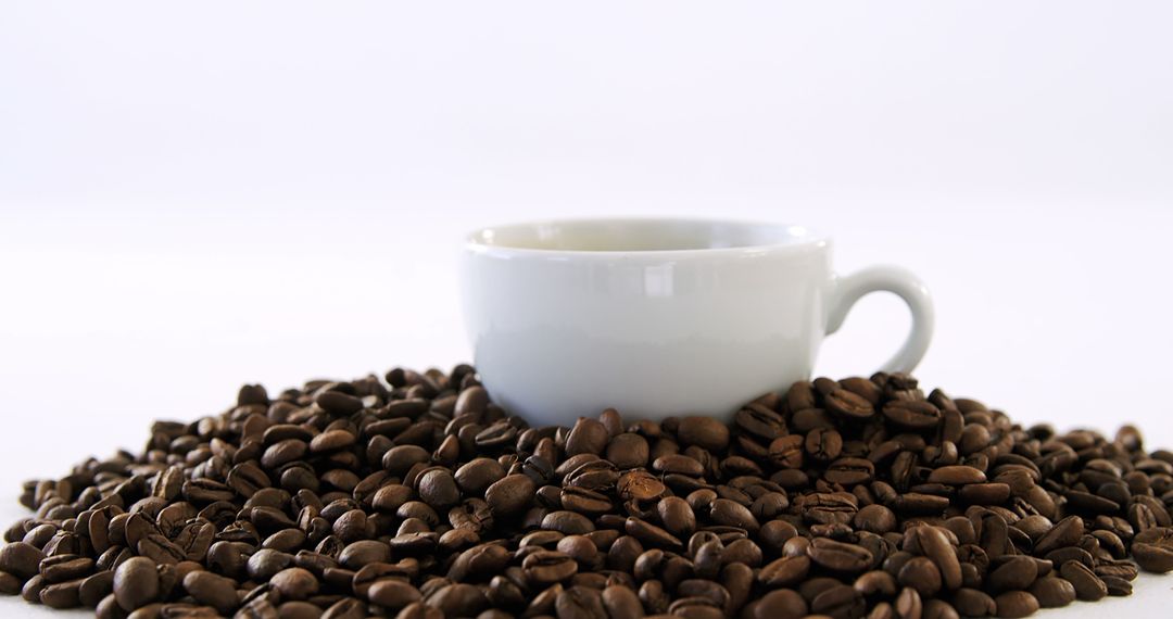 White Ceramic Cup Surrounded by Roasted Coffee Beans - Free Images, Stock Photos and Pictures on Pikwizard.com