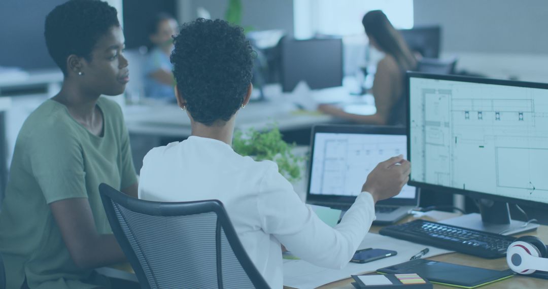 Team Collaborating on Architectural Designs in Modern Office