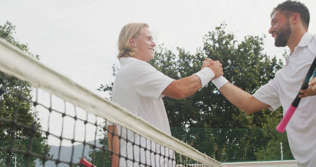 Male Tennis Players Shaking Hands Over Net in Greeting on Court - Free Images, Stock Photos and Pictures on Pikwizard.com