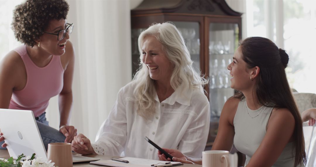 Diverse Women Collaborating in Team Meeting with Technology