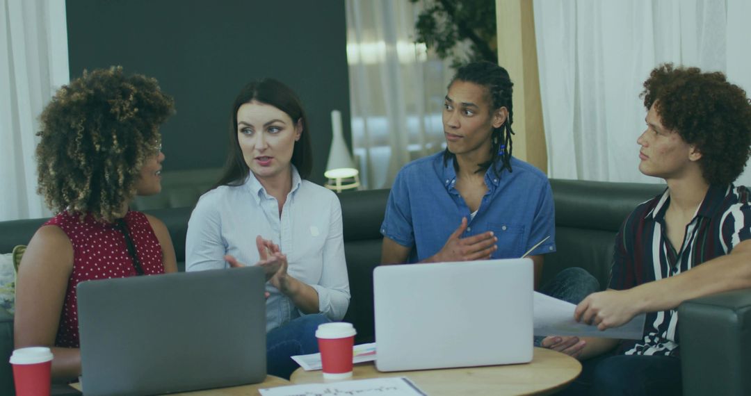 Group of Diverse Professionals Having Collaborative Meeting in Modern Lounge