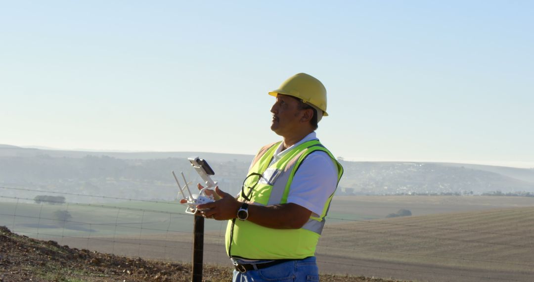 Engineer Operating Drone in Field with Wind Turbine in Background
