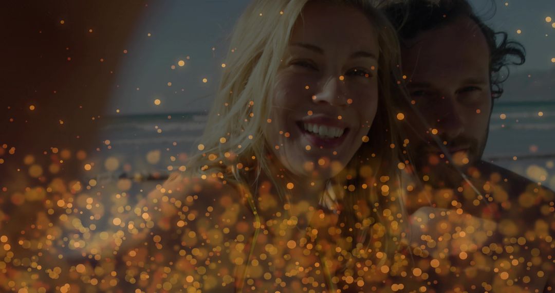 Smiling couple enjoying romantic beach sunset with golden bokeh and ocean horizon