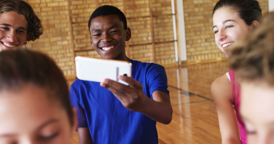 Teenagers Taking Selfie in Gymnasium, Smiling and Happy - Free Images, Stock Photos and Pictures on Pikwizard.com