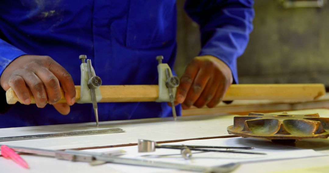 Carpenter Measuring Wooden Plank with Compass in Workshop - Free Images, Stock Photos and Pictures on Pikwizard.com