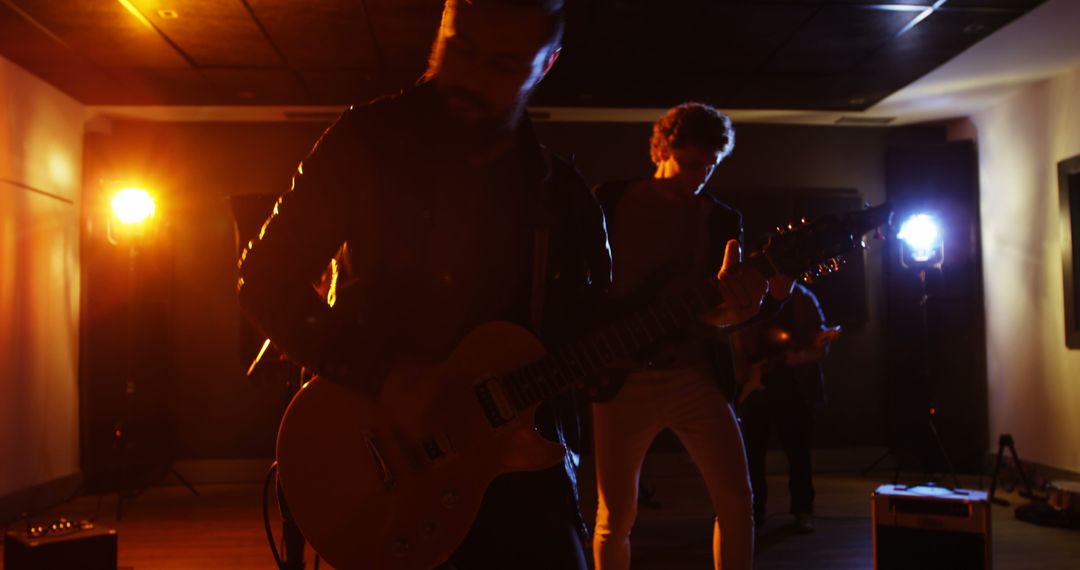 Guitarist Jamming in Dimly Lit Recording Studio