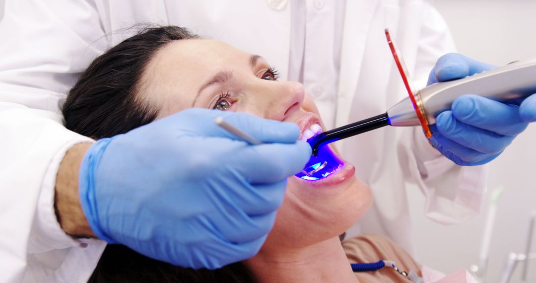 Patient Undergoing Dental Treatment with Light Curing Lamp - Free Images, Stock Photos and Pictures on Pikwizard.com