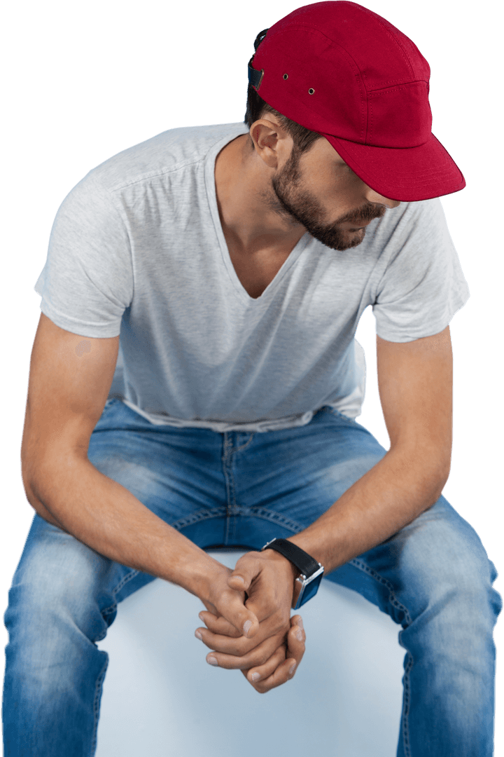 Caucasian Man with Red Hat Sitting on Transparent Background