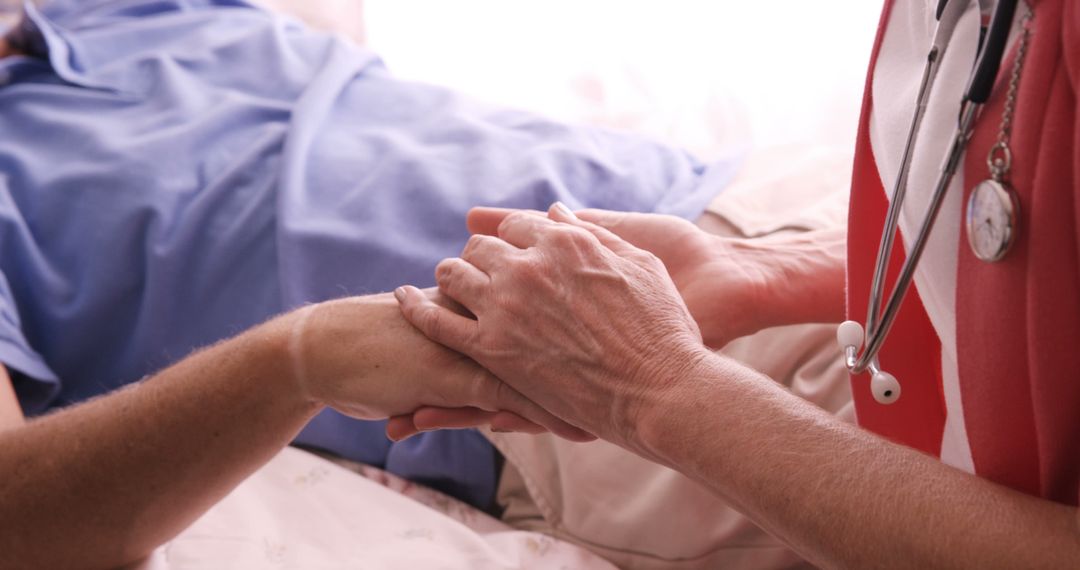 Compassionate Nurse Holding Patient's Hand in Hospital Room - Free Images, Stock Photos and Pictures on Pikwizard.com