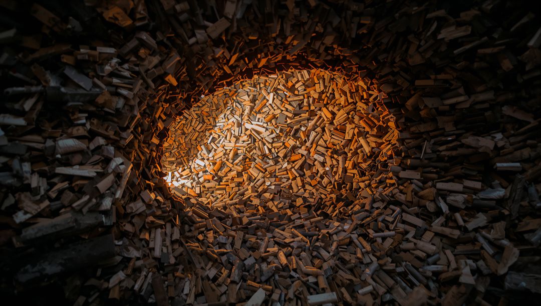 Glowing Pile of Split Firewood Forming Circular Timber Nest with Warm Ambient Light