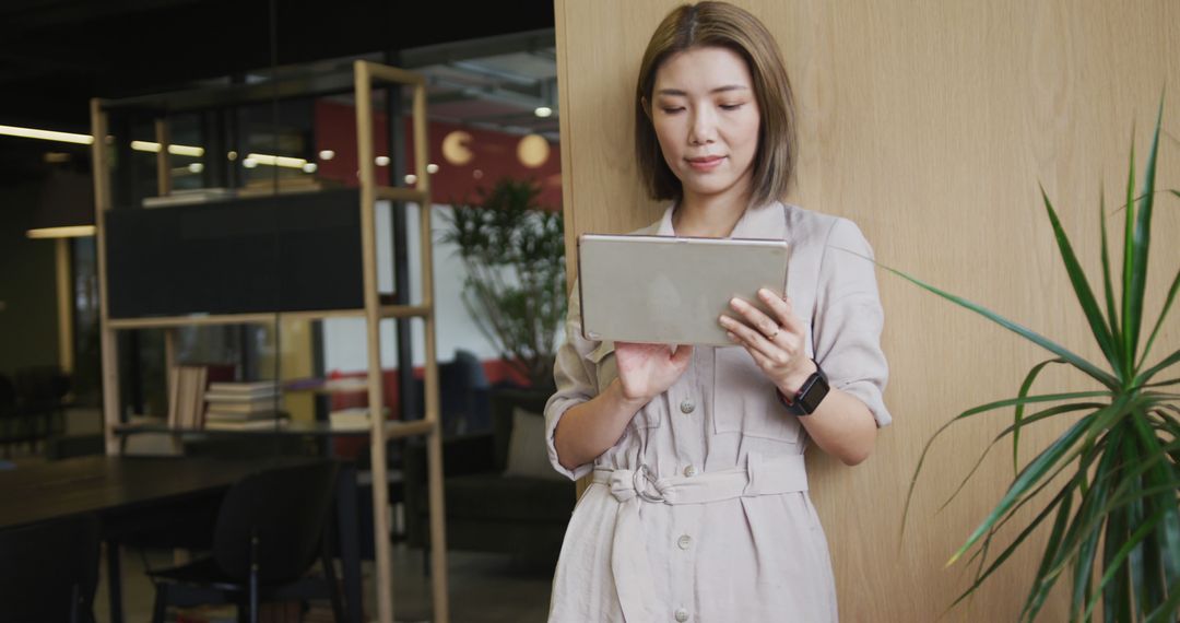 Businesswoman Using Tablet in Modern Open Office Space - Free Images, Stock Photos and Pictures on Pikwizard.com