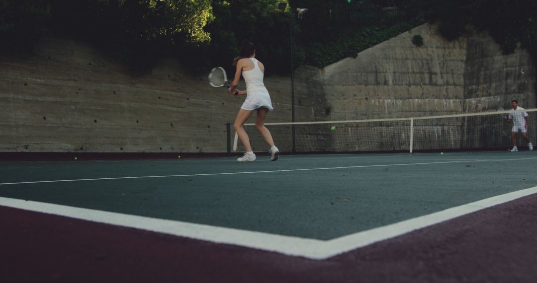 People Playing Tennis on Outdoor Court - Free Images, Stock Photos and Pictures on Pikwizard.com