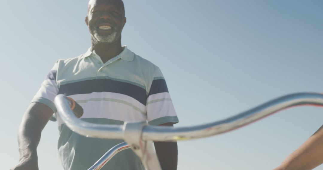 Smiling Senior Man Riding Bicycle on a Sunny Day - Free Images, Stock Photos and Pictures on Pikwizard.com