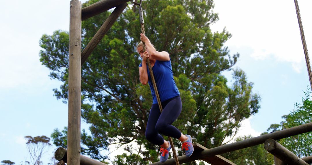 Woman Participating in Outdoor Rope Course Challenge - Free Images, Stock Photos and Pictures on Pikwizard.com