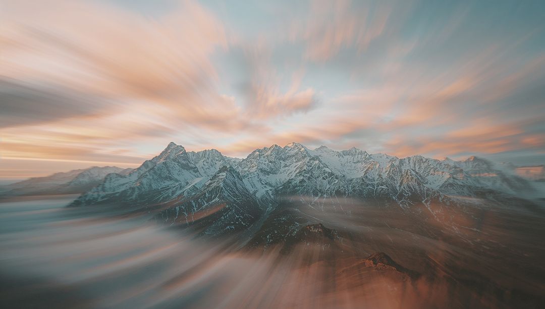 Snow-Capped Mountains with Stunning Cloud Swirl Effect