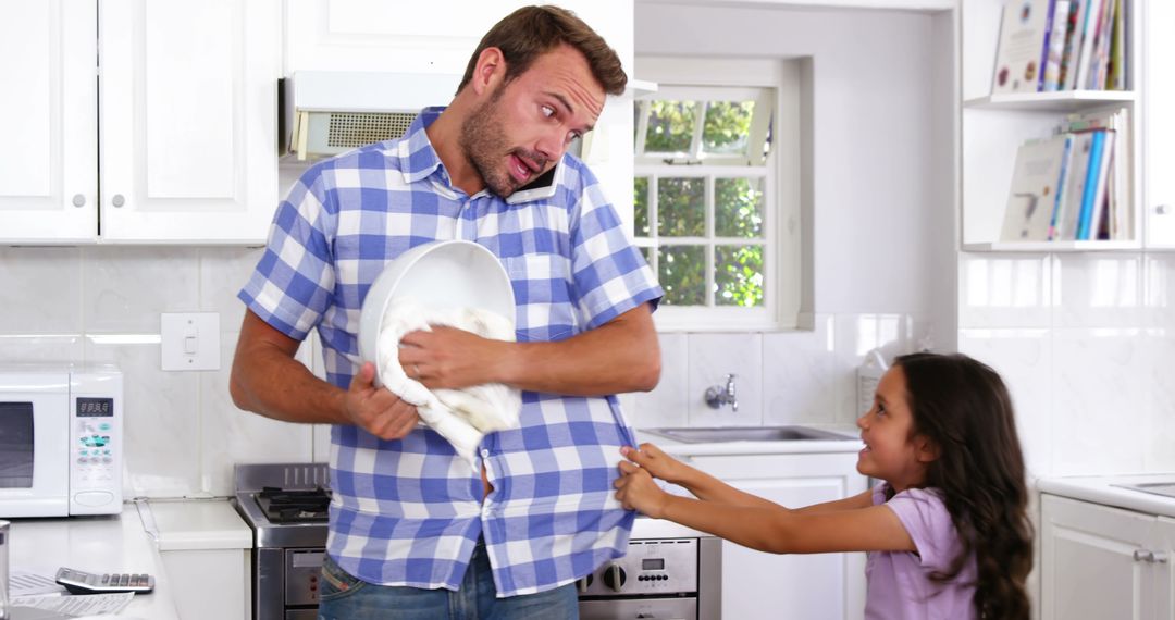 Father and Daughter Playful Baking in Kitchen
