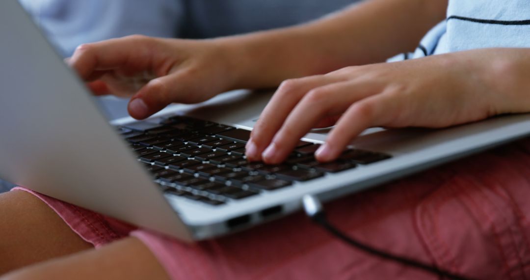 Close-up of child's hands typing on laptop keyboard - Free Images, Stock Photos and Pictures on Pikwizard.com