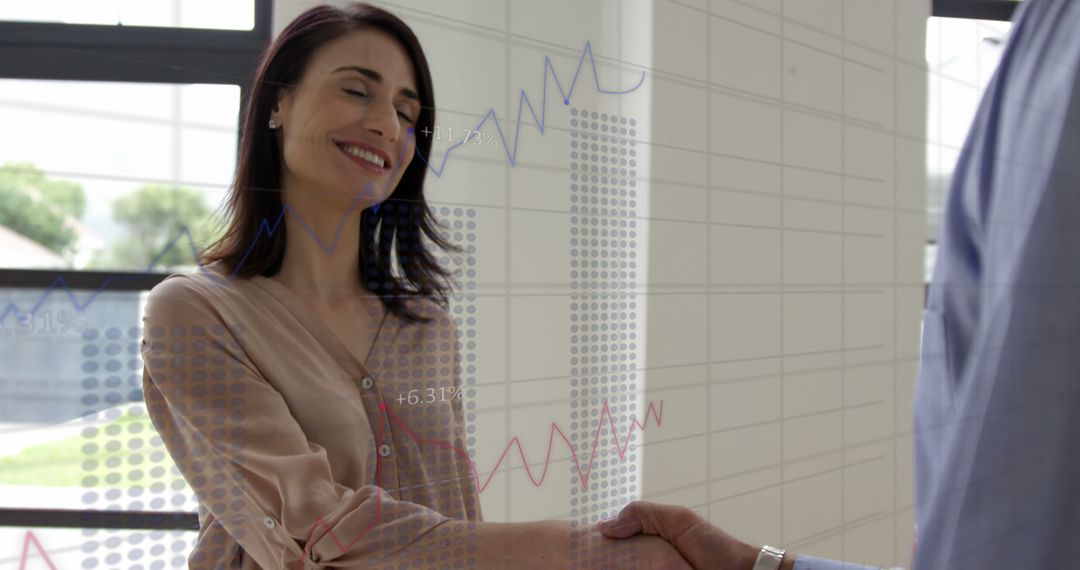 Business Professionals Shaking Hands with Overlay of Financial Data