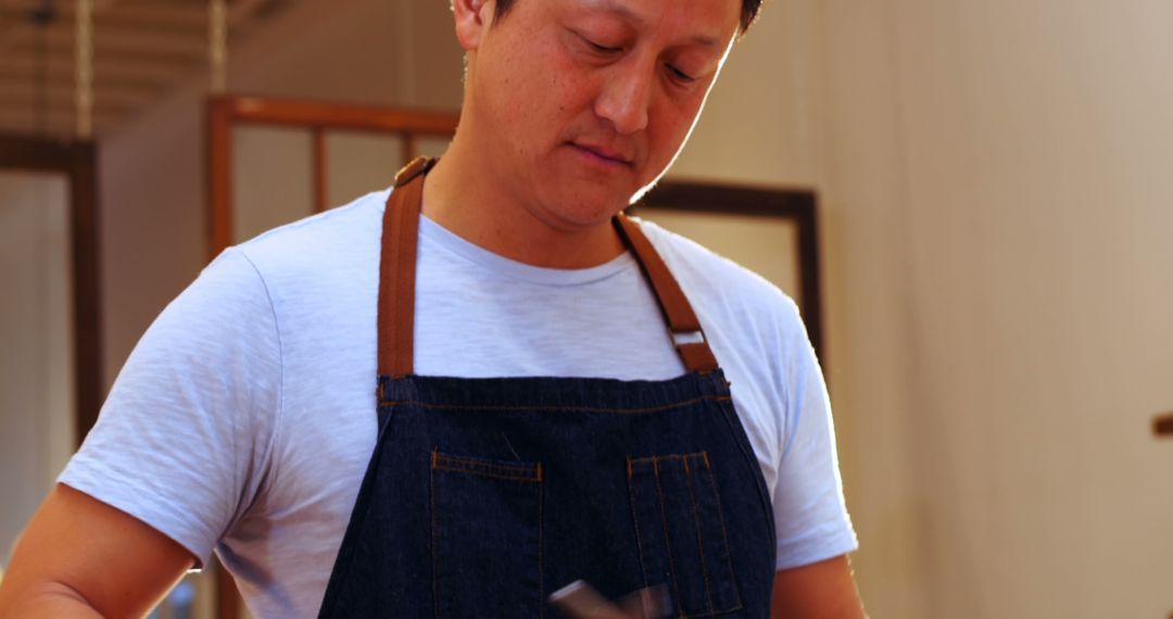 Male Barista Grinding Coffee Beans in Denim Apron - Free Images, Stock Photos and Pictures on Pikwizard.com