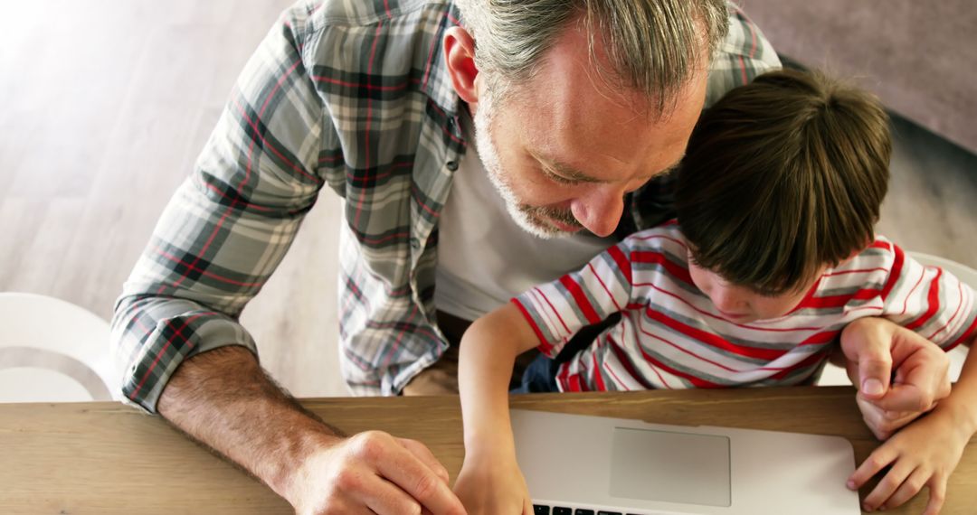 Father and Child Using Computer at Home - Free Images, Stock Photos and Pictures on Pikwizard.com