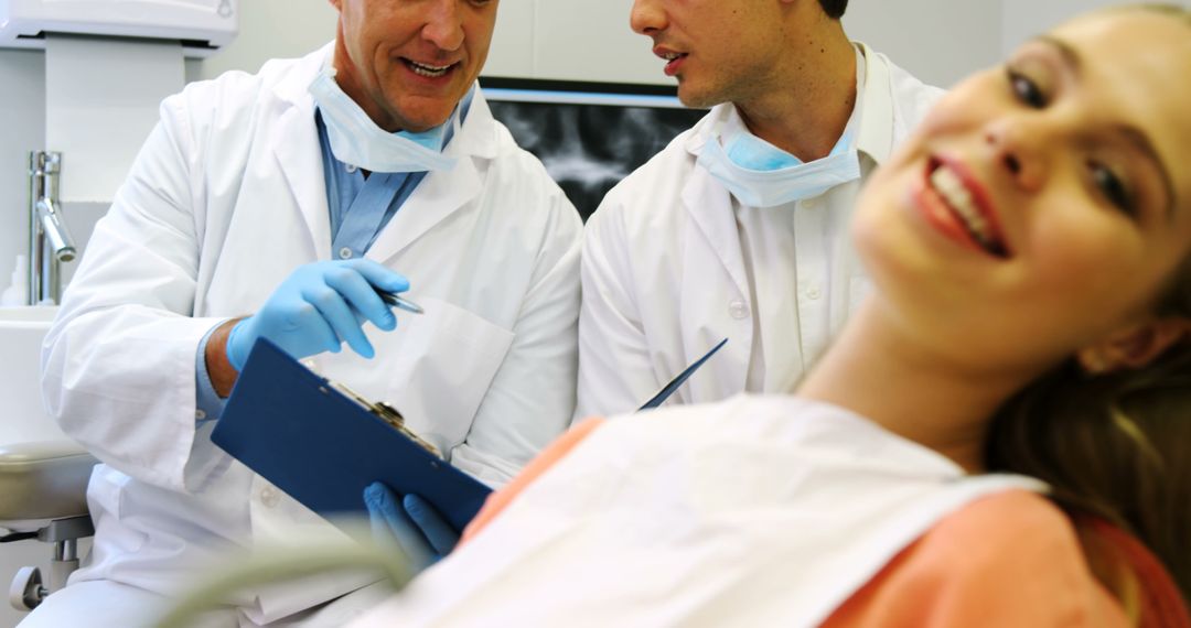 Dentists Examining Patient, Smiling Woman in Dental Clinic - Free Images, Stock Photos and Pictures on Pikwizard.com