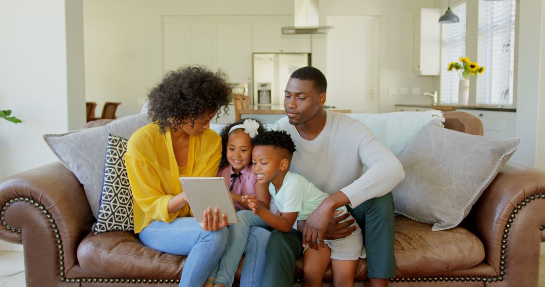 Happy African American Family Using Tablet in Cozy Living Room - Free Images, Stock Photos and Pictures on Pikwizard.com