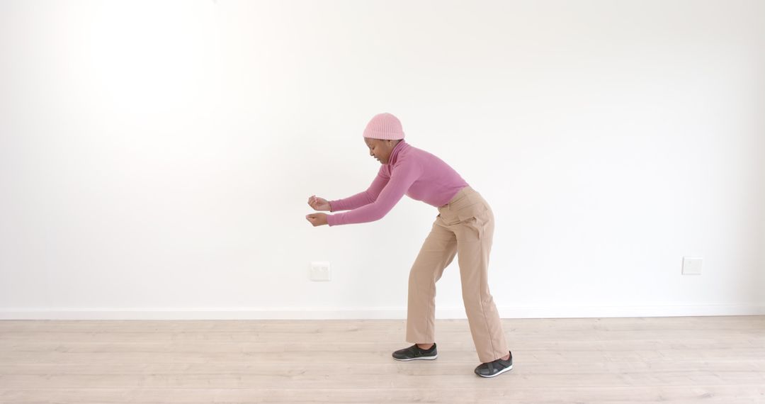 Trendy Individual Dancing Energetically in Minimalist Space