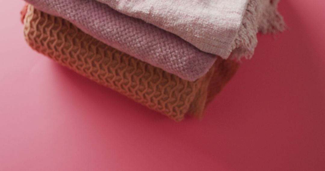 Image of folded blankets lying on pink background - Free Images, Stock Photos and Pictures on Pikwizard.com