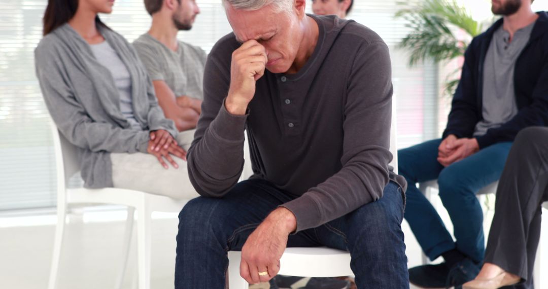 Man experiencing emotional stress during group therapy session - Free Images, Stock Photos and Pictures on Pikwizard.com