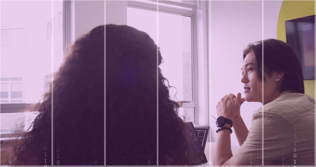 Women Colleagues Collaborating in Modern Meeting Room
