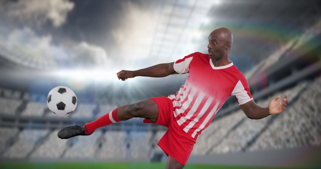 Focused Soccer Player Kicking Ball in Stadium Highlighted by Sunlight