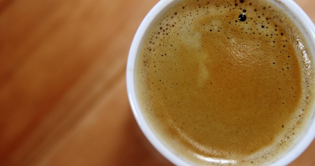 Close-Up View of Freshly Brewed Cup of Coffee on Wooden Table - Free Images, Stock Photos and Pictures on Pikwizard.com