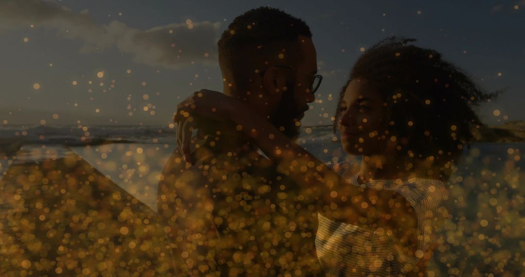 Couple Embracing at Sunset on Beach with Golden Bokeh and Backlit Silhouette