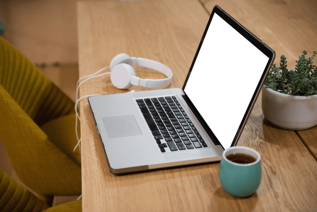 Transparent Laptop Screen with Headphones and Cup on Office Table