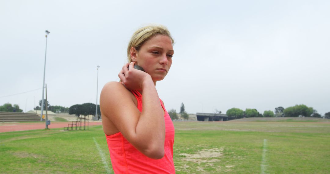 Young Female Athlete Preparing to Throw Shot Put Outdoors - Free Images, Stock Photos and Pictures on Pikwizard.com