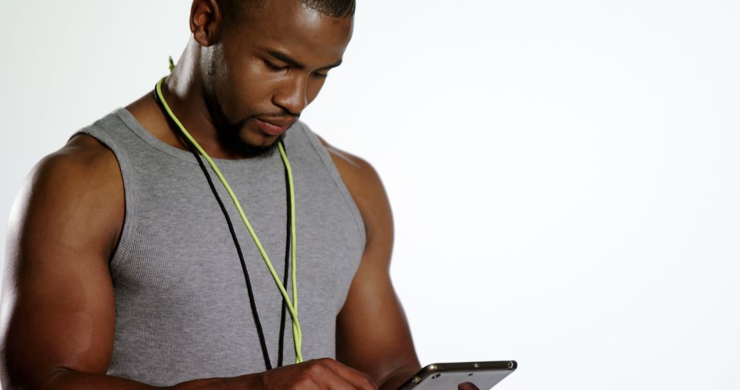 Fit Young Man Using Smartphone and Listening to Music - Free Images, Stock Photos and Pictures on Pikwizard.com