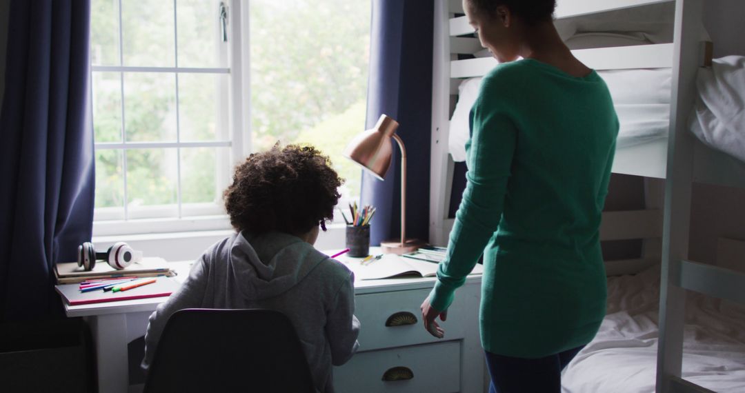 Mother Helping Child with Homework in Bedroom - Free Images, Stock Photos and Pictures on Pikwizard.com