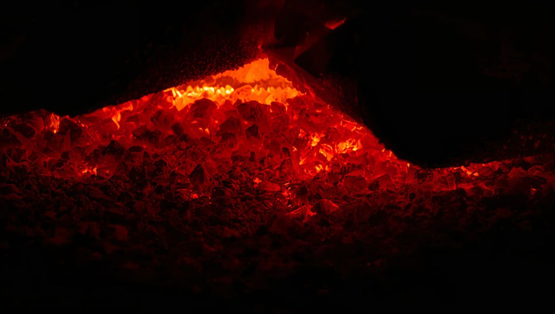 Smoldering Charcoal Embers Glowing in Furnace Chamber with Deep Red Heat and Ash