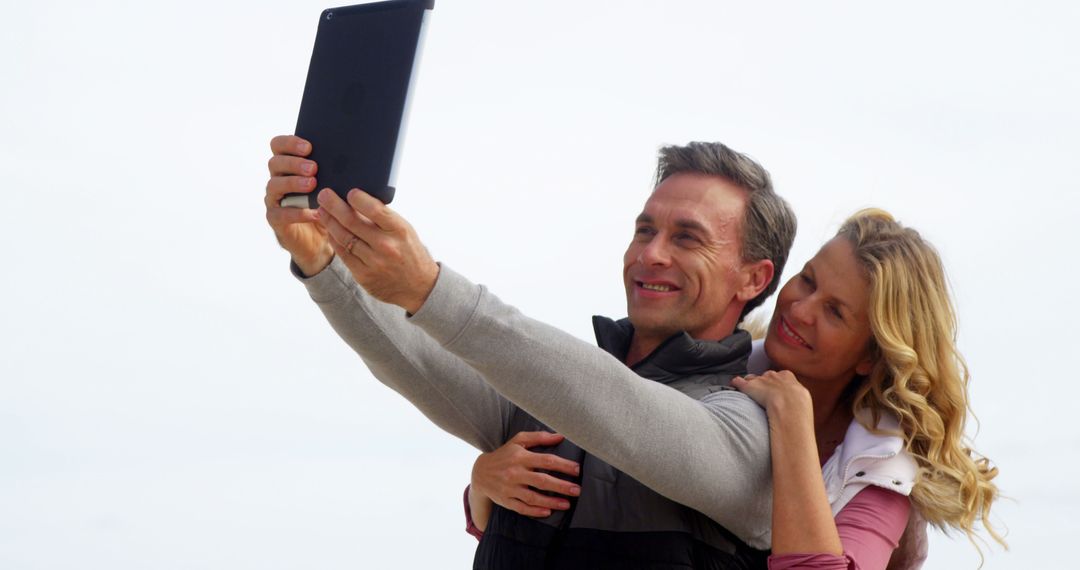 Middle-Aged Couple Joyfully Taking Selfie with Tablet