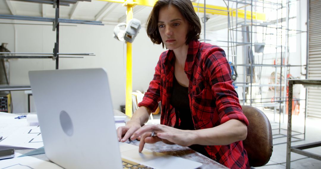 Female Industrial Designer Working on Laptop in Workshop - Free Images, Stock Photos and Pictures on Pikwizard.com