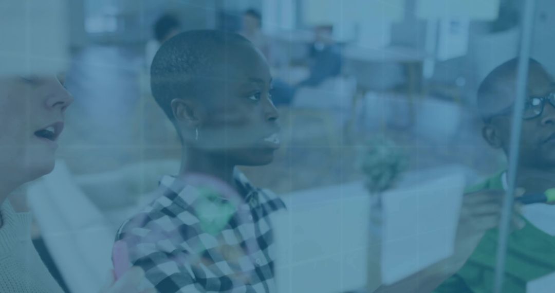 Team Collaborating on Glass Whiteboard with Sticky Notes in Modern Office