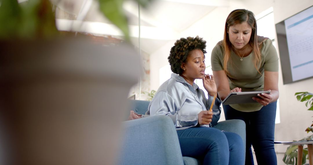 Diverse Female Colleagues Discussing Business Strategies with Tablet