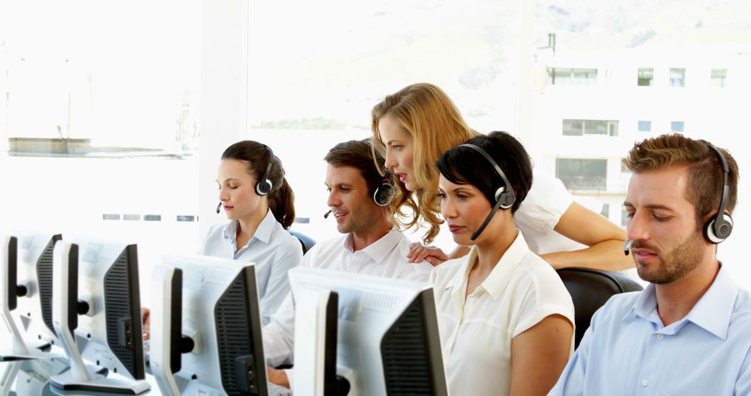 Customer Service Team Working at Call Center with Headsets - Free Images, Stock Photos and Pictures on Pikwizard.com