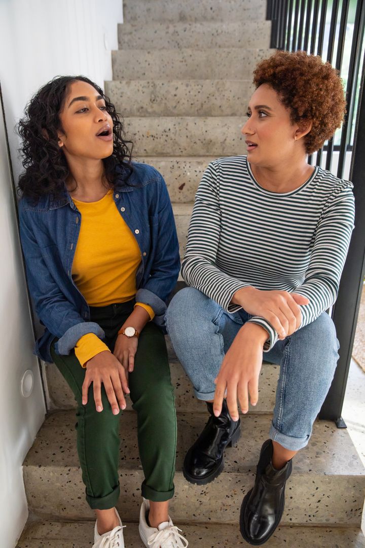 Diverse Friends Enjoying a Casual Conversation on Indoor Steps