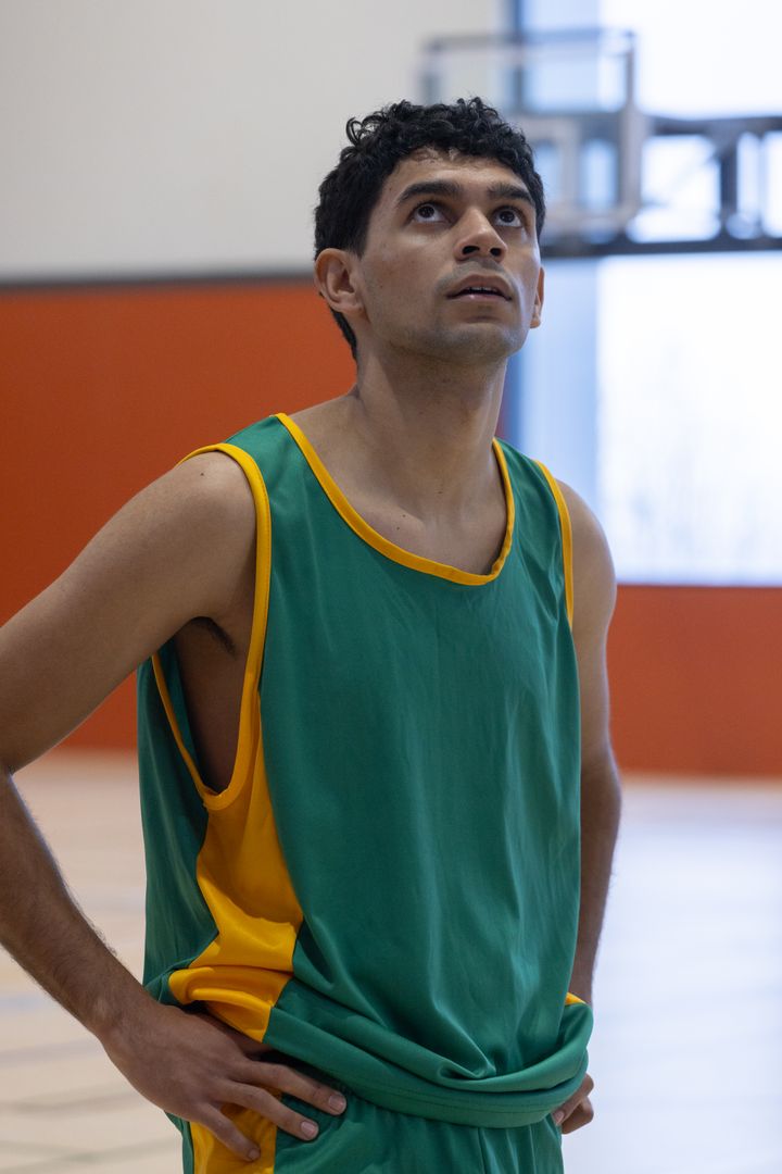 Focused Basketball Player in Gym Gazing at Hoop